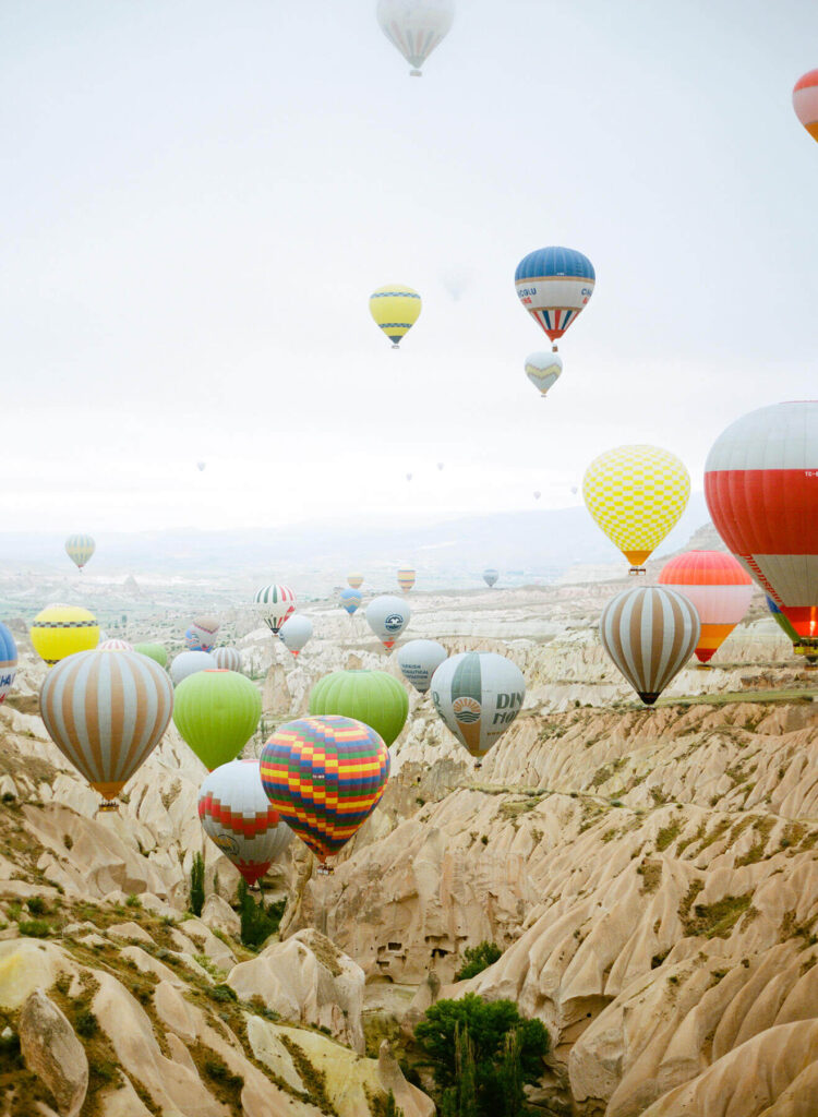 Hot air balloons taking flight together, used to describe the concept of social self care