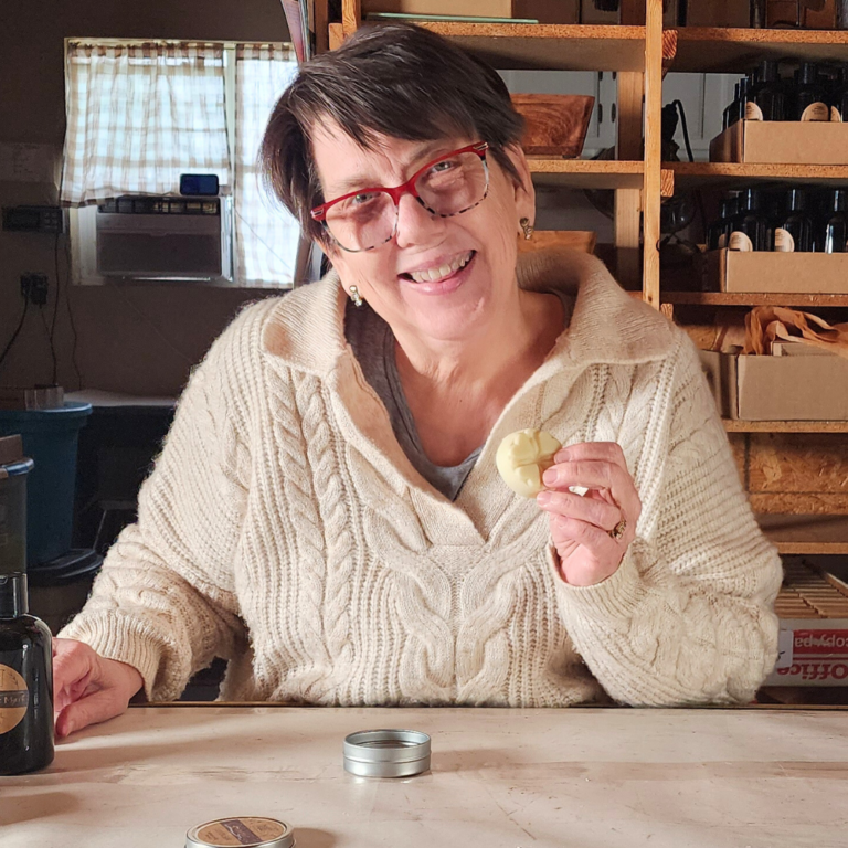 Susan Svec holding a lotion bar, an excellent barrier for dry winter skin